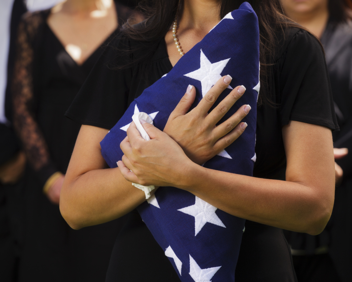 Flag held to heart